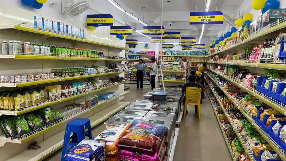 BringBasket store aisle with staff stocking shelves
